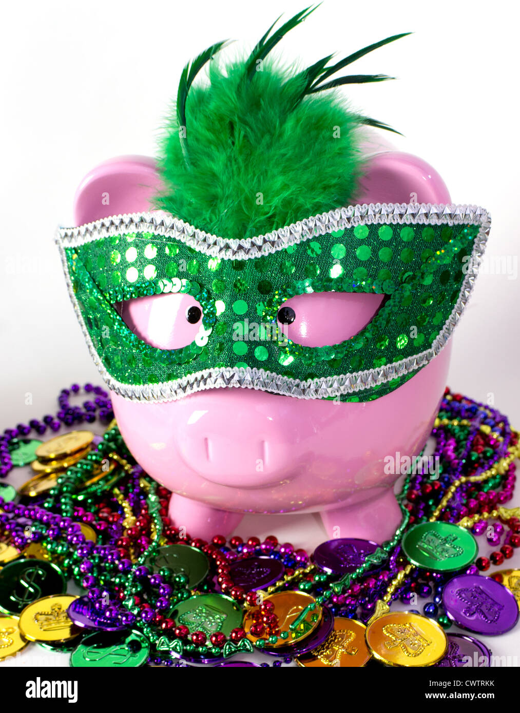 Mardi Gras piggy pank on a pile of Mardi Gras beads and coins Stock Photo