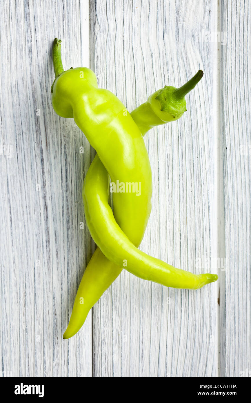 green chili pepper on white kitchen table Stock Photo