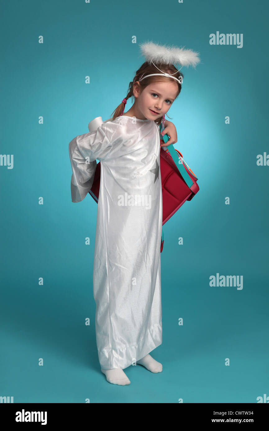 Girl dressed up as angel wearing schoolbag Stock Photo