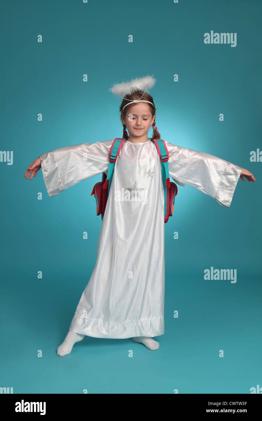 Girl dressed up as angel wearing schoolbag Stock Photo