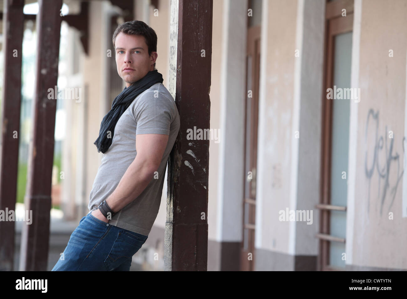 Brunette man in T-shirt and scarf outdoors Stock Photo