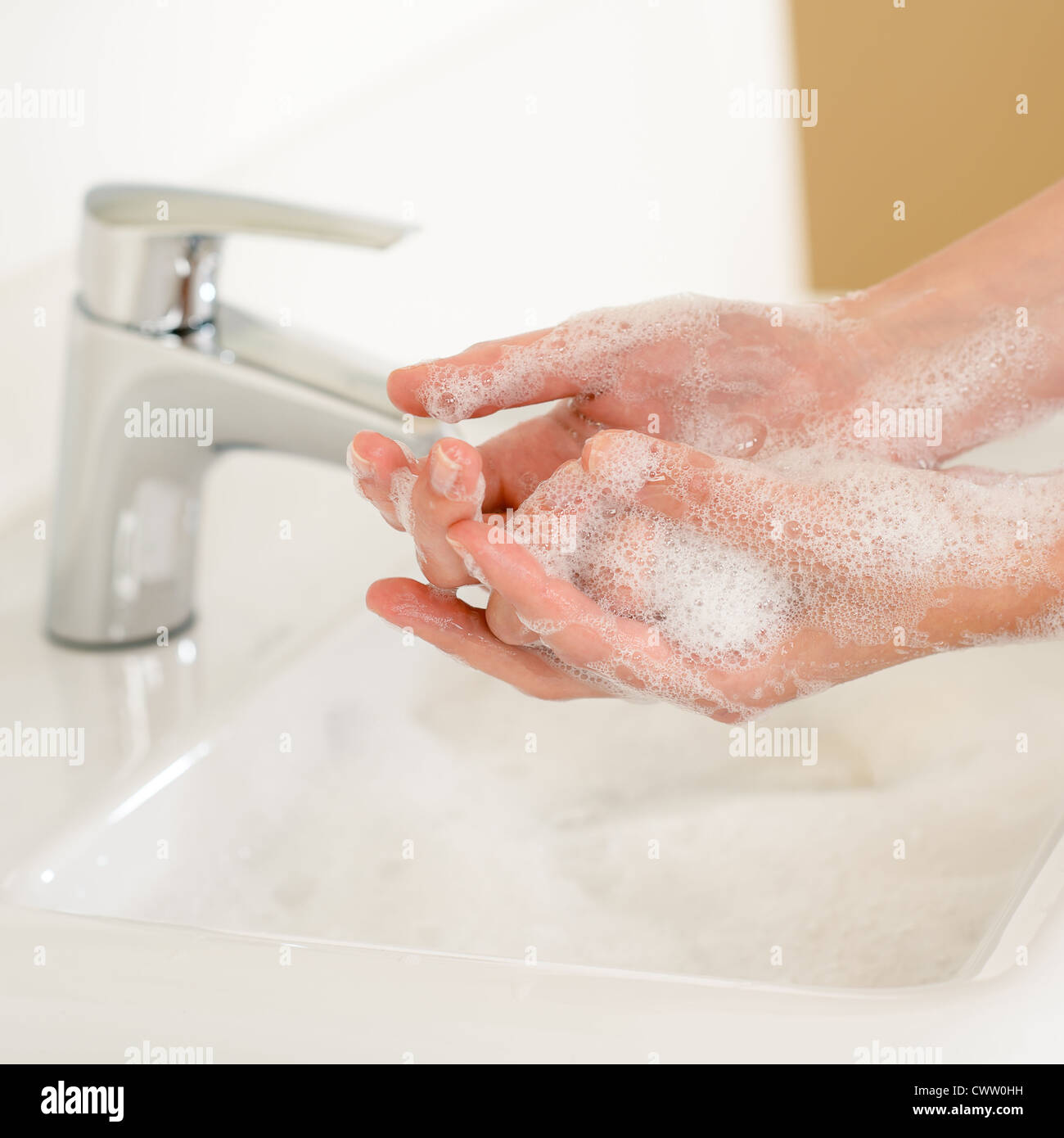 Close-up of washing hands with soap above bathroom sink Stock Photo - Alamy