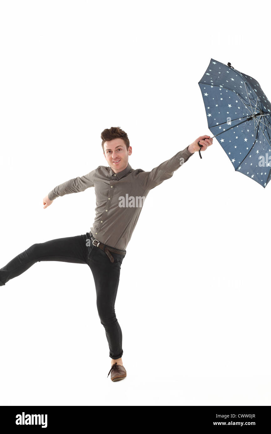 Handsome man with a blue umbrella with stars Stock Photo - Alamy