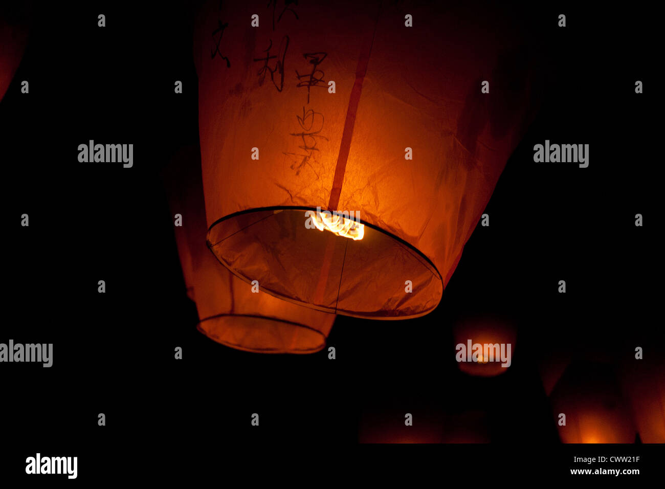 Big Chinese sky lanterns drift into the night during the lantern festival two weeks after Chinese New Year in Pingxi, Taiwan. Stock Photo