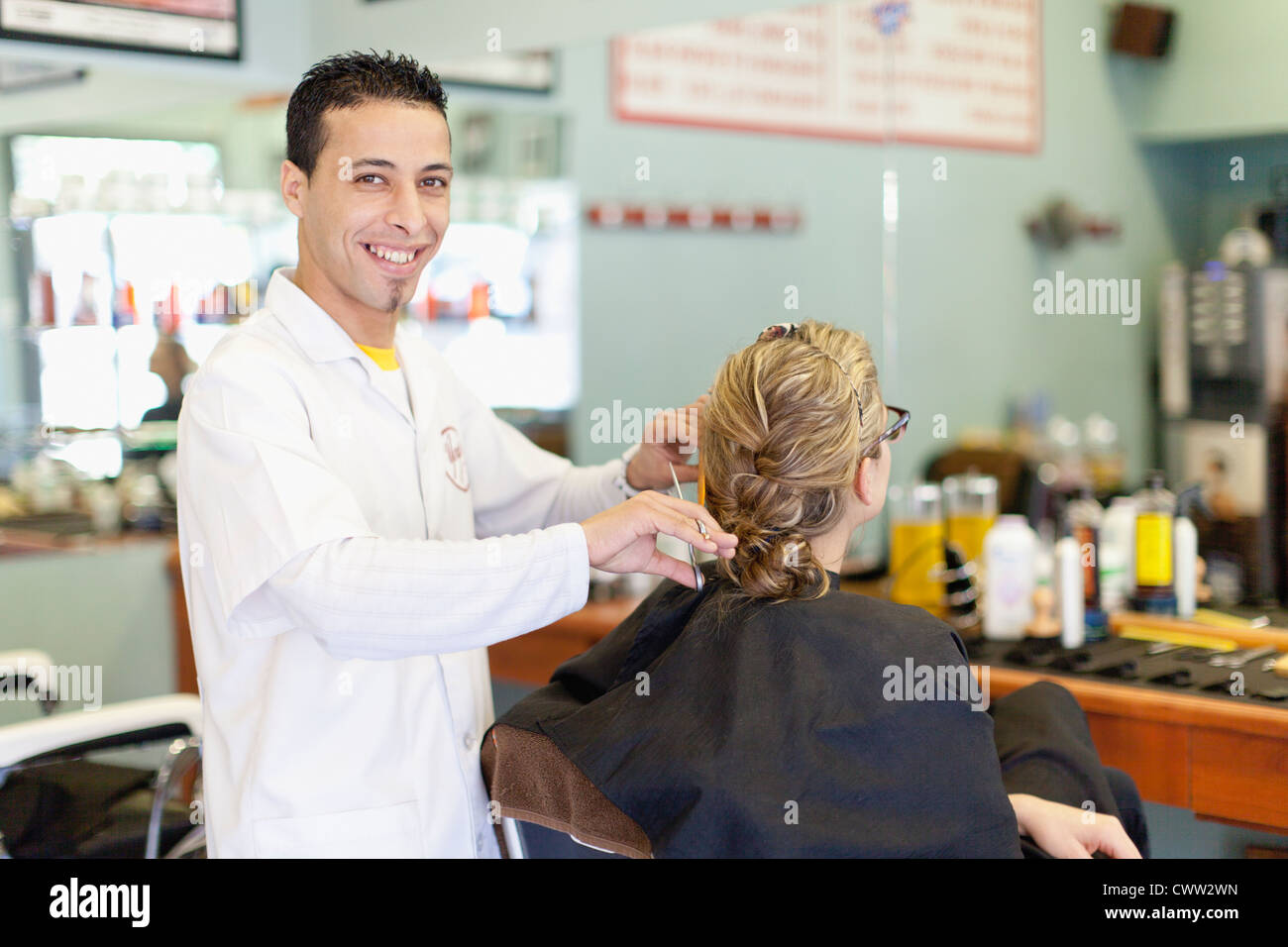 Barber working on client in shop Stock Photo Alamy