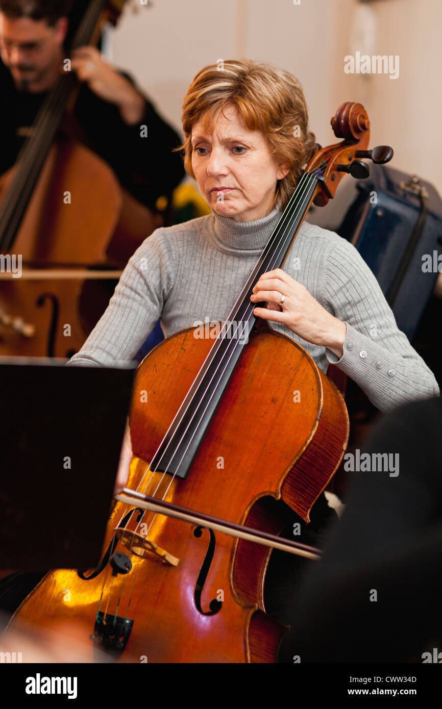Cello player practicing with group Stock Photo