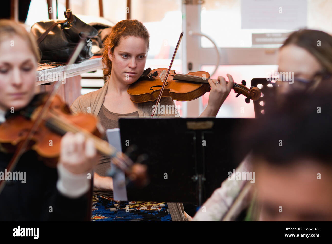Violin player practicing with group Stock Photo
