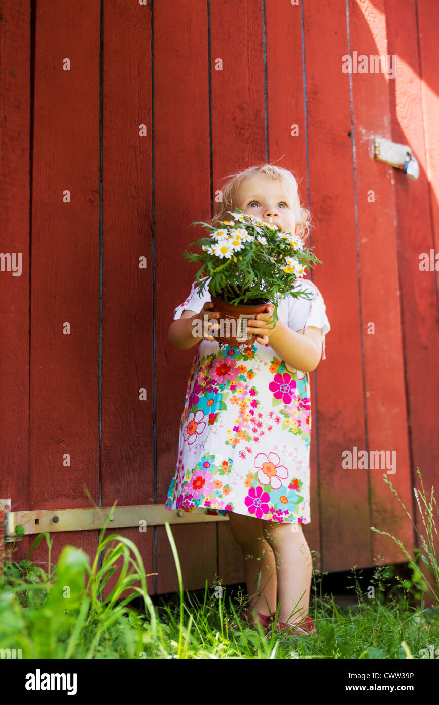 Girl holding potted plant outdoors Stock Photo - Alamy