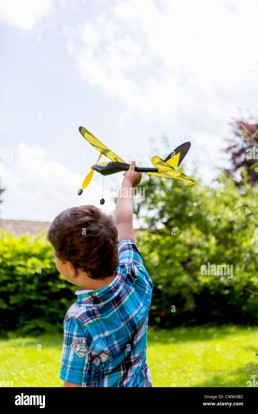 Boy playing with toy airplane outdoors Stock Photo - Alamy