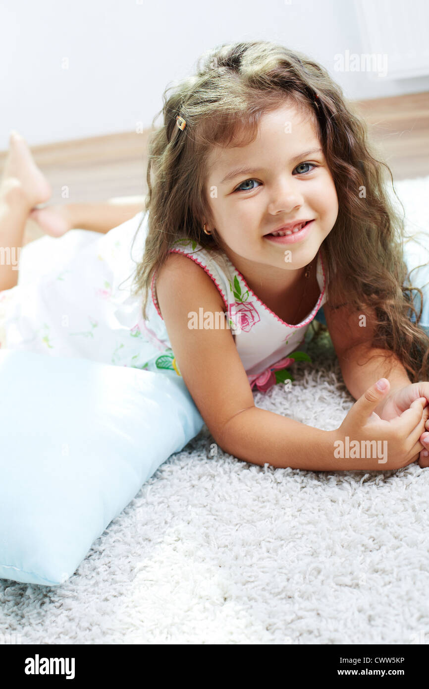 Portrait of lovely girl lying on the floor at home Stock Photo - Alamy