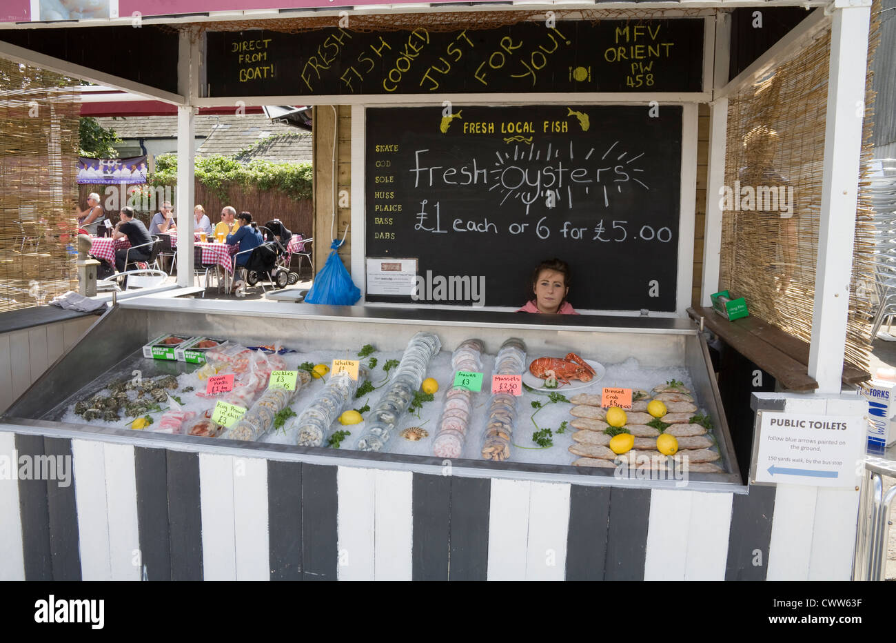 Whitstable Shellfish Whitstable Kent England UK August Young woman waiting for customers for ...