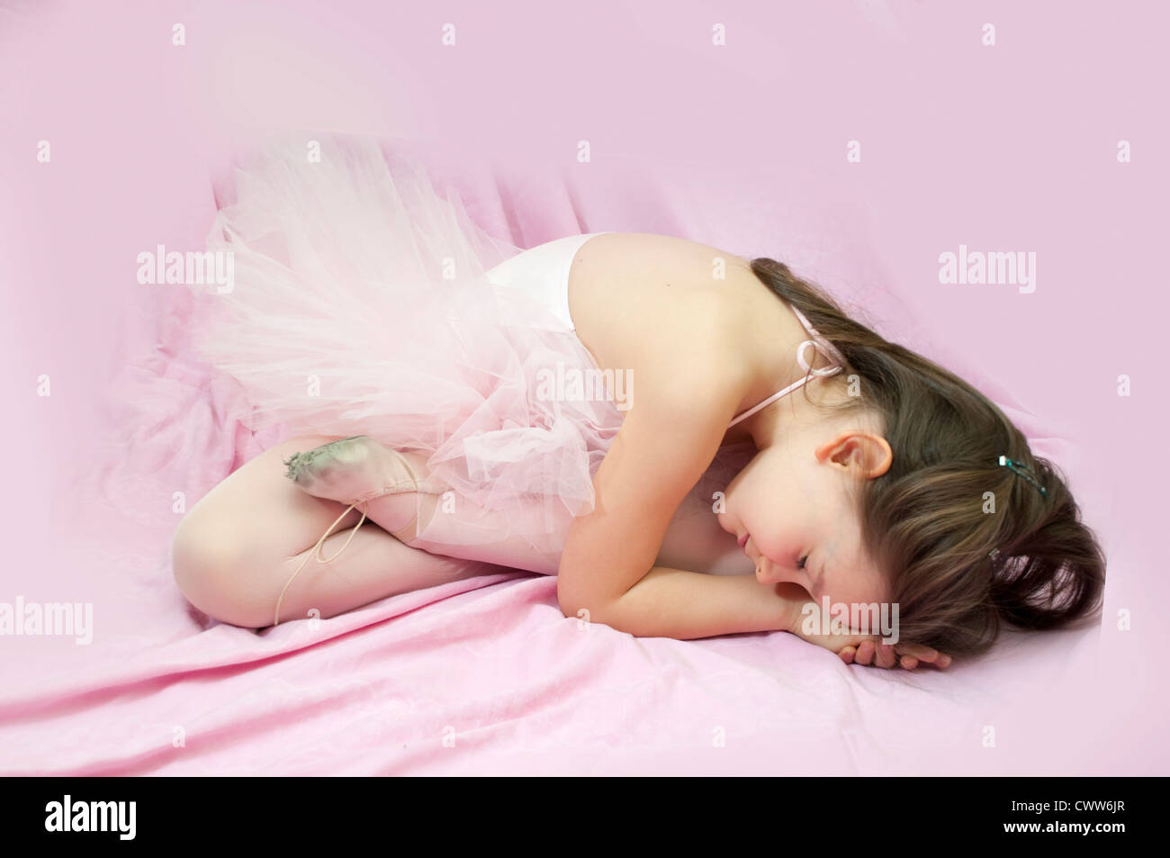 Portrait of sweet little ballerina girl on the floor Stock Photo