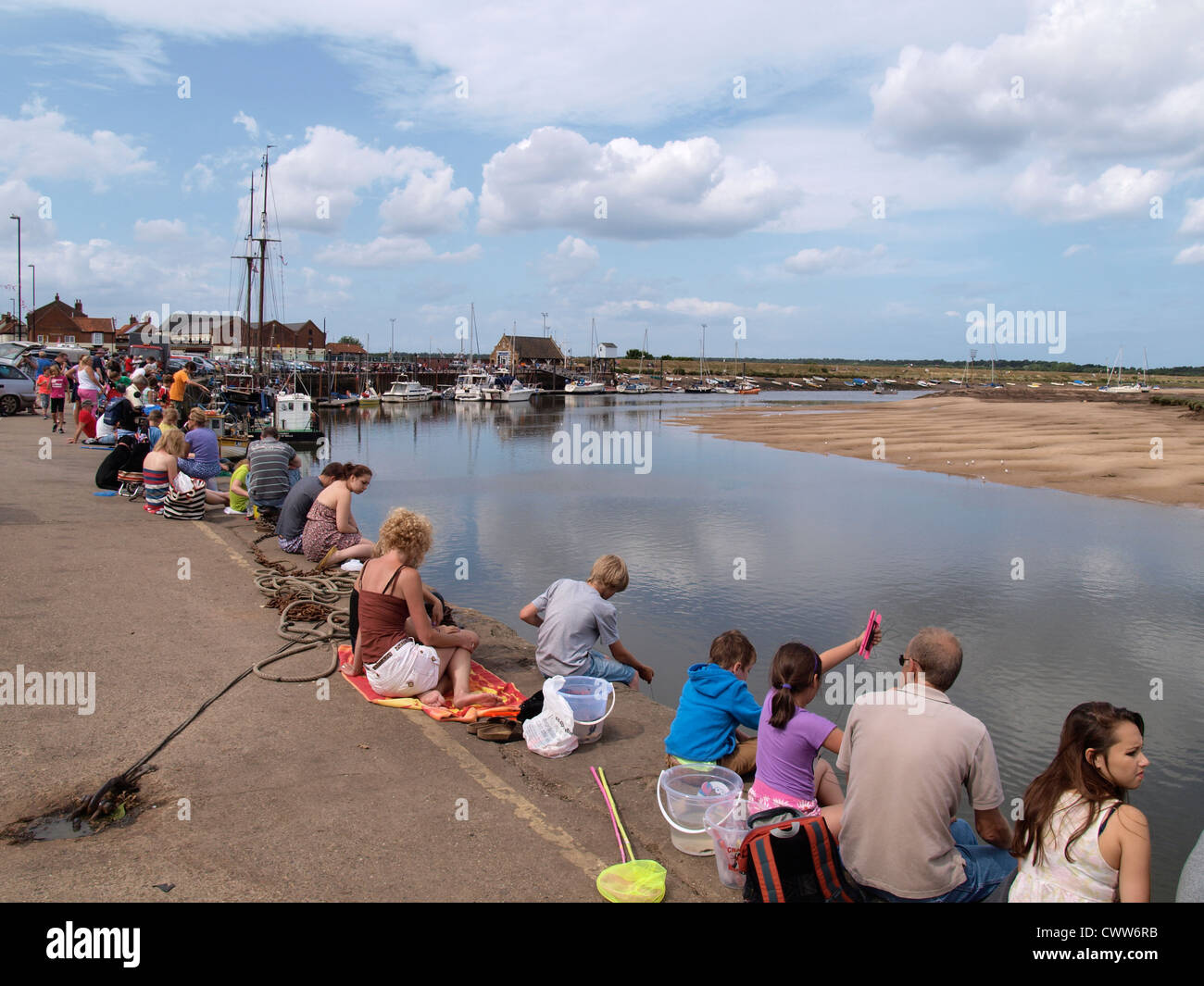 Crab fishing on the harbour at Wells-Next-The-Sea, Norfolk, UK Stock Photo