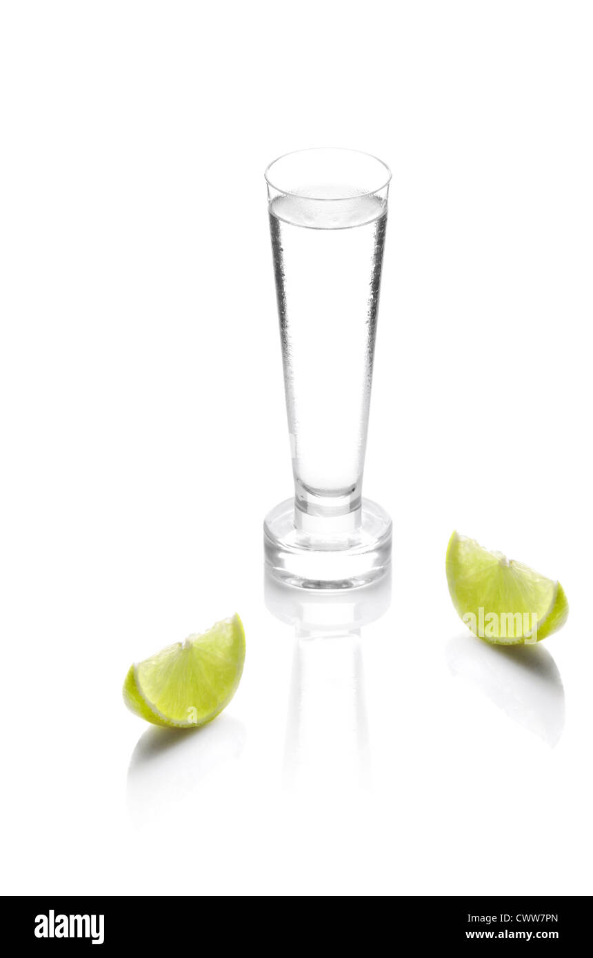shot glass filled with clear cold alcohol isolated on white Stock Photo
