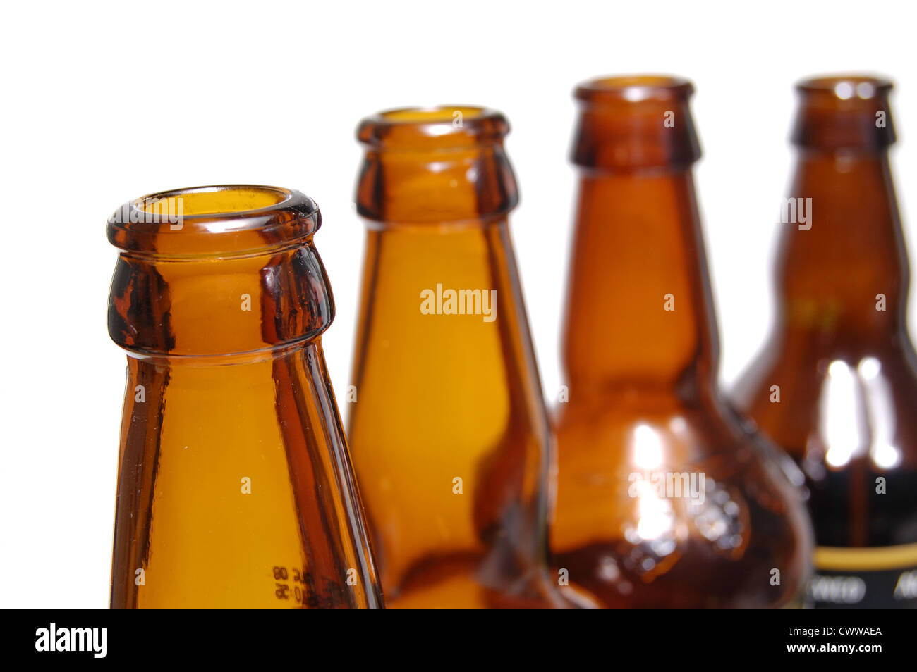 Row of glass bottles against a white background Stock Photo - Alamy