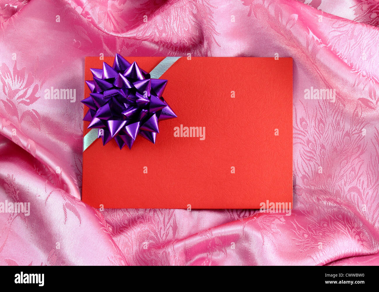 red blank gift card with ribbon on pink satin Stock Photo Alamy
