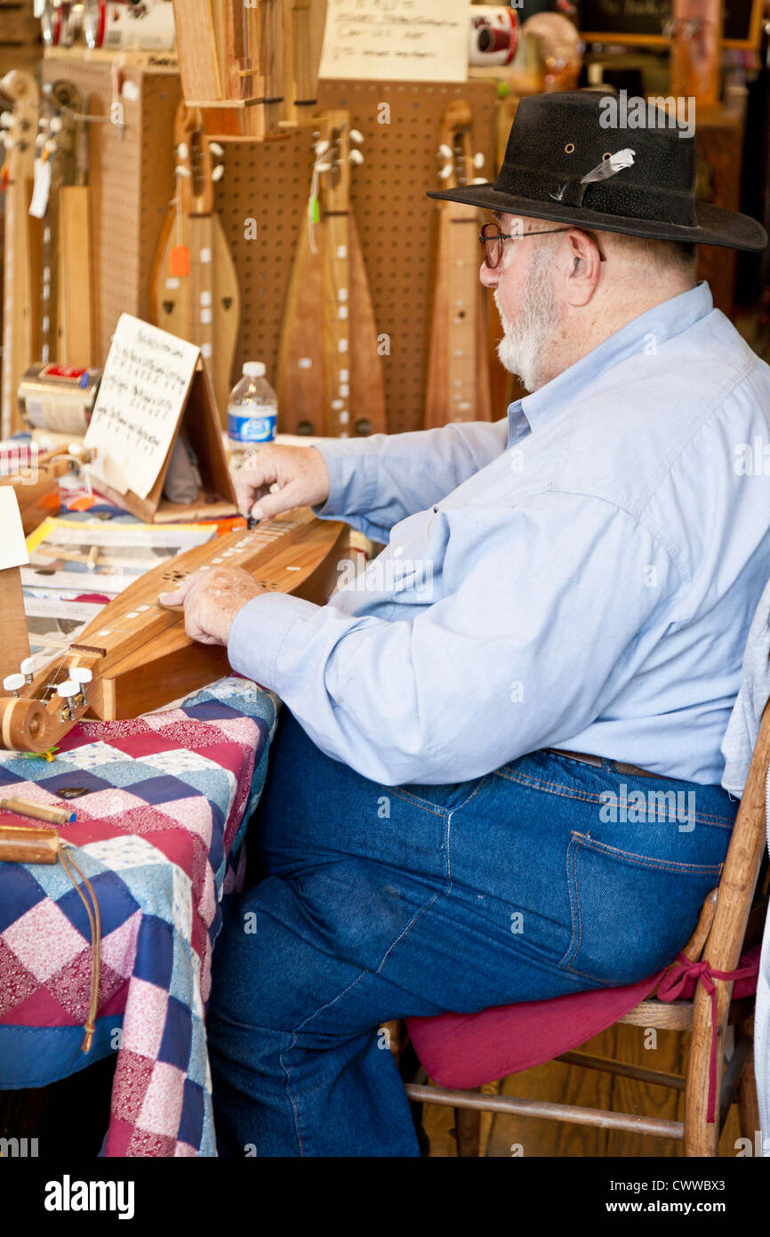 Man plays and sells hand made dulcimers at Billie Creek Village in