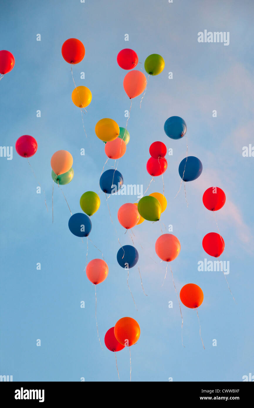 Bunch of balloons floating in sky Stock Photo