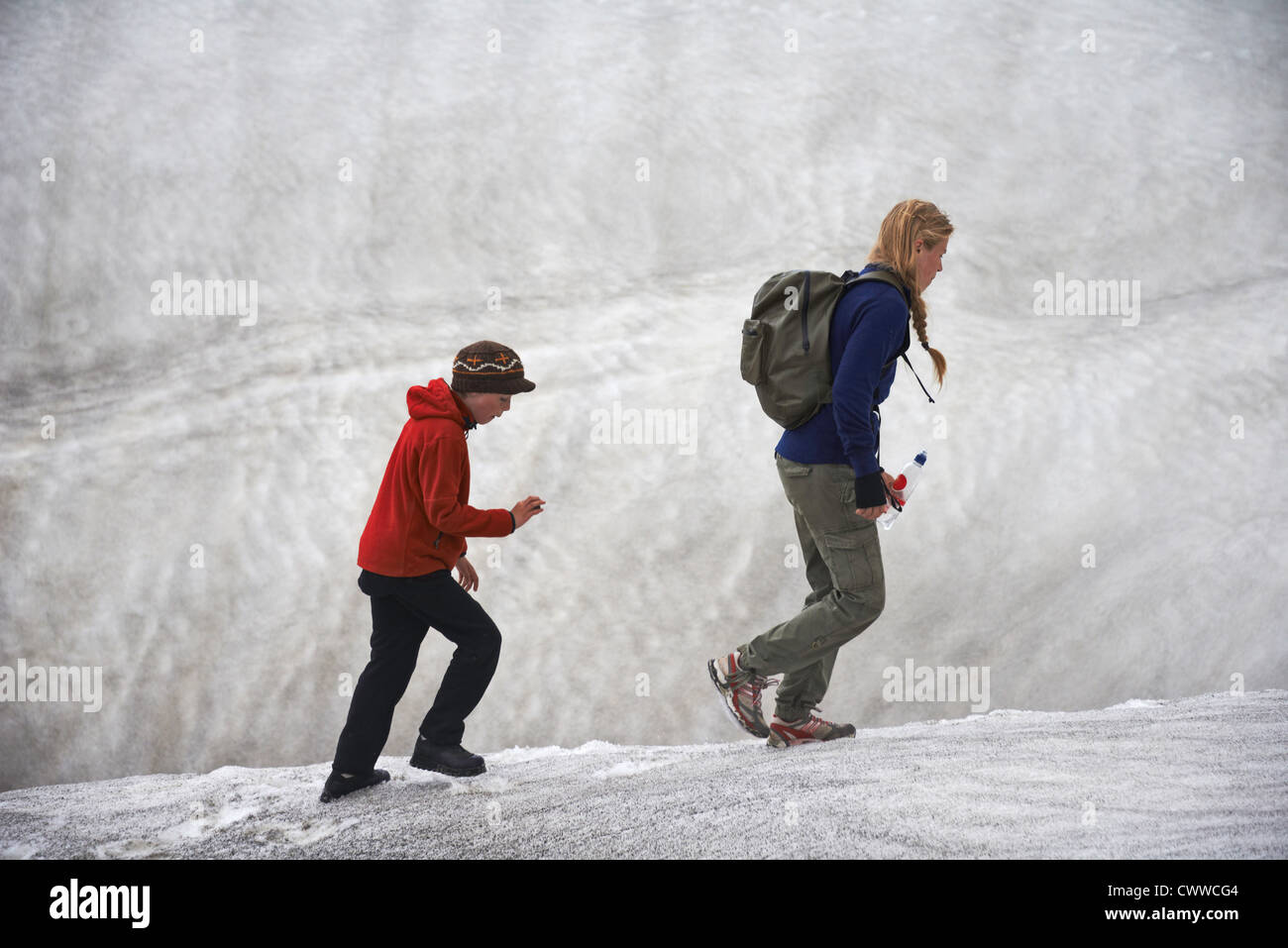 Mother and daughter on snowy hillside Stock Photo