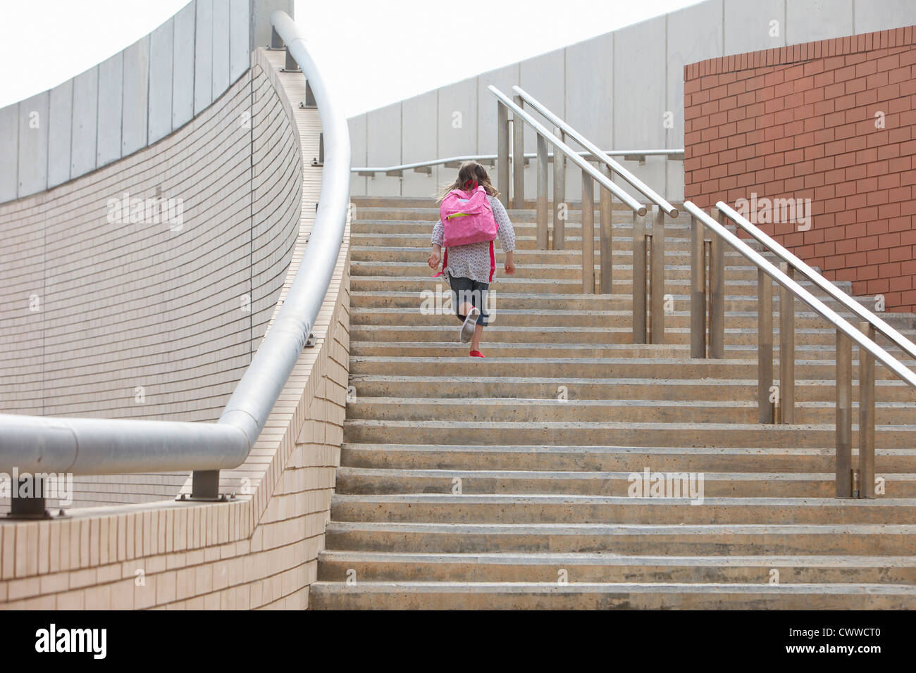 Girl climbing steps outdoors Stock Photo Alamy