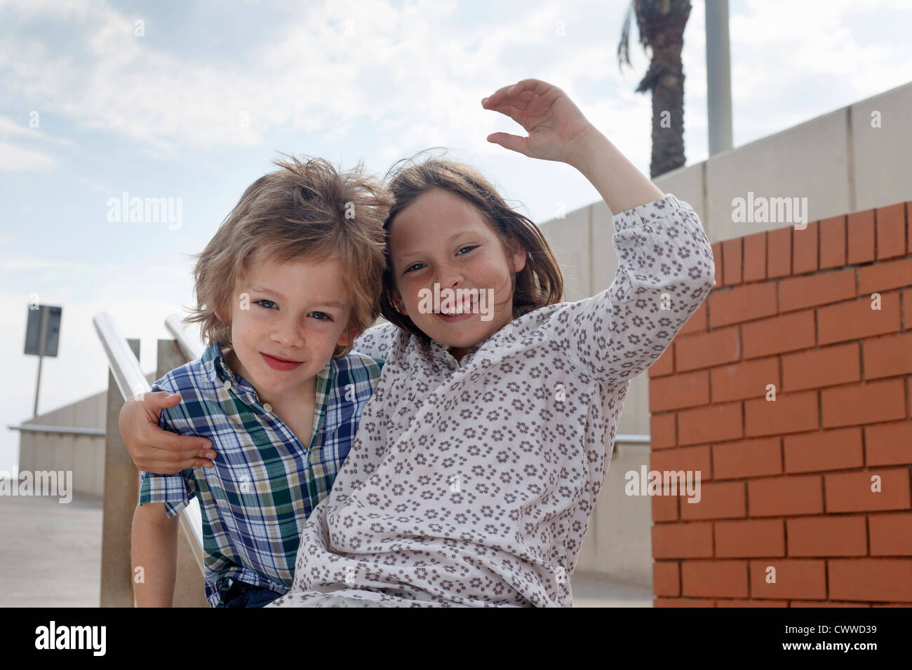 Children sliding down banister on steps Stock Photo Alamy