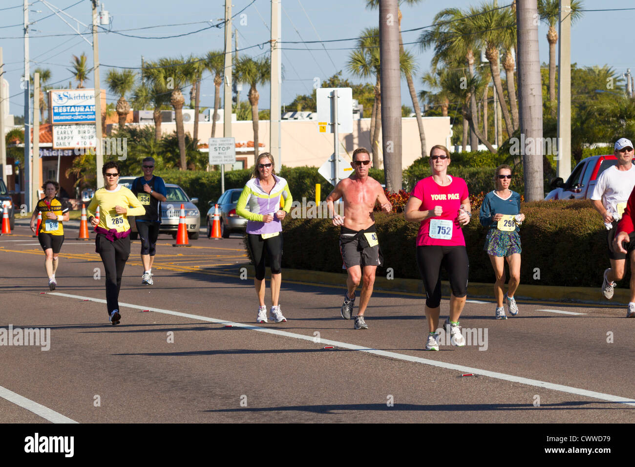 Men and women running in 5k and 10k run on streets of St. Pete Beach, Florida Stock Photo