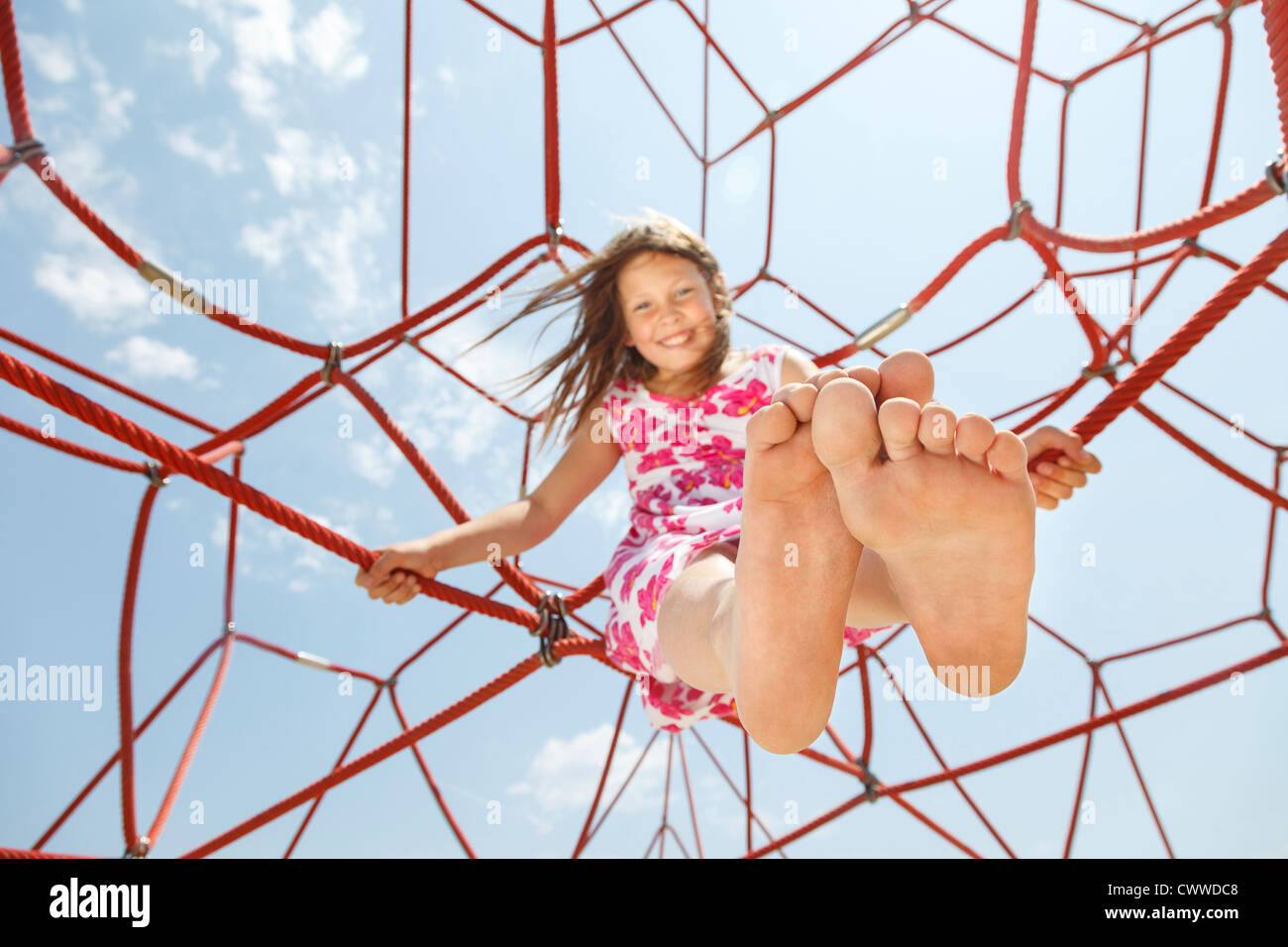 Girl playing on ropes outdoors Stock Photo Alamy