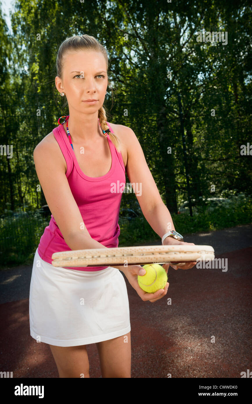 Tennis player serving on court Stock Photo