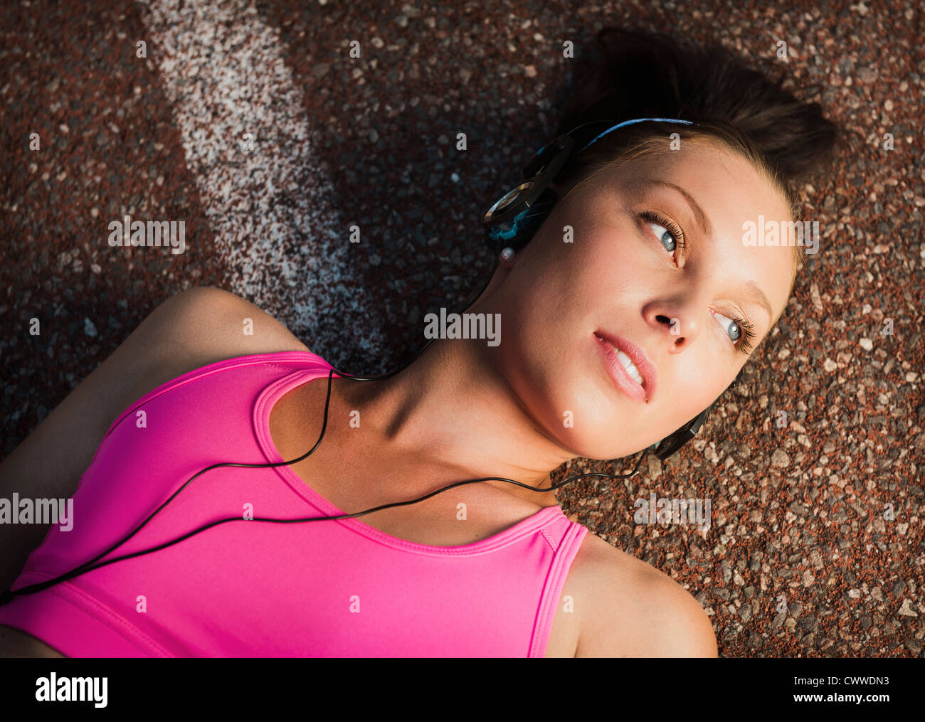 Woman laying on sidewalk Stock Photo