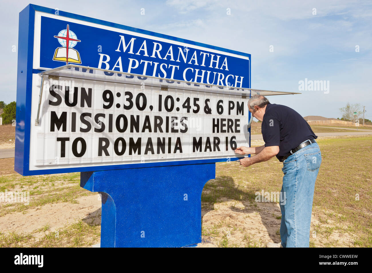 Church member changing message on sign outside Maranatha Baptist Church in Ocala, Florida Stock Photo