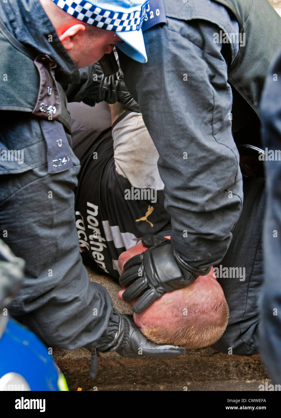 Territorial Support Team TSG  police arresting member of the EDL English Defence League Stock Photo