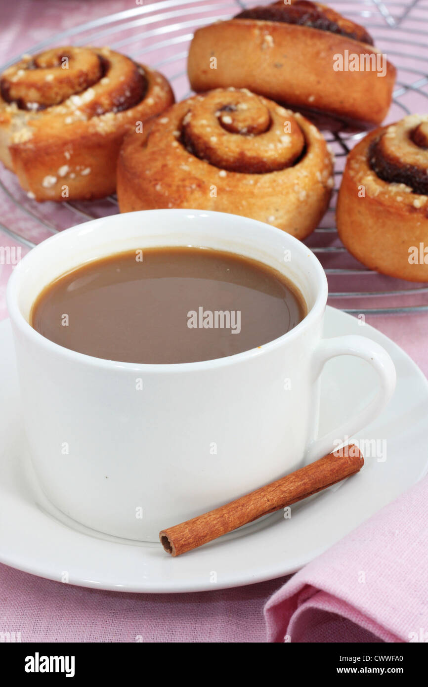 A cup of coffee with freshly baked cinnamon rolls Stock Photo