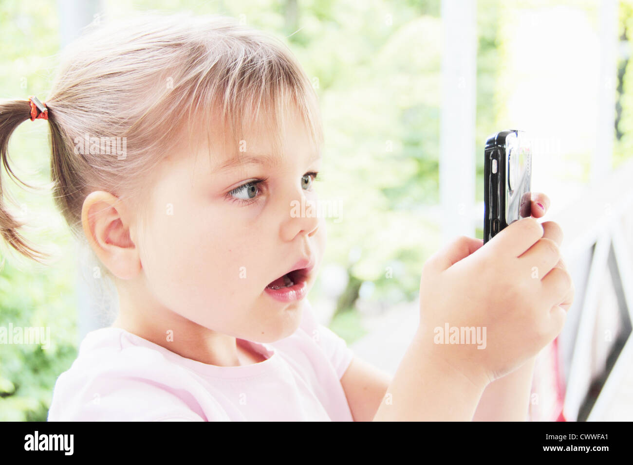 Toddler playing with cell phone Stock Photo