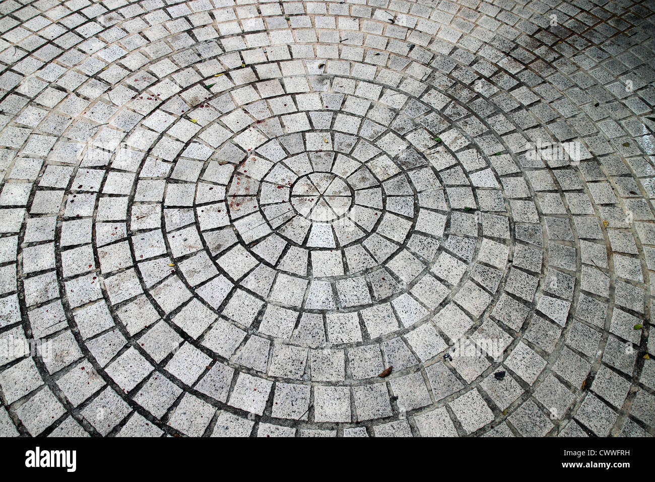 Closeup view on a cobblestone road - circle pattern - background Stock Photo