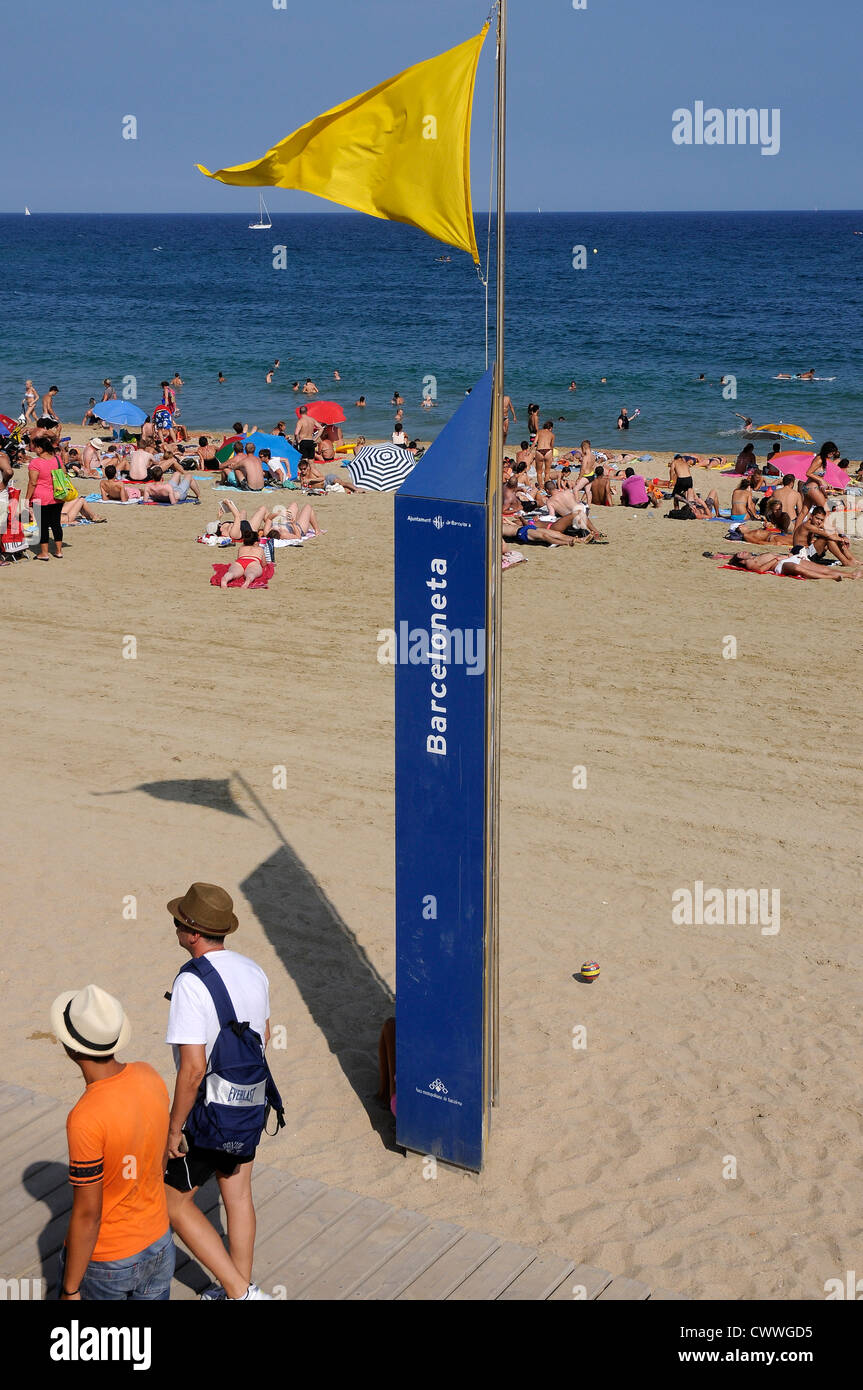 Barcelona beach  yellow flag indicates that precaution to swimmers Stock Photo