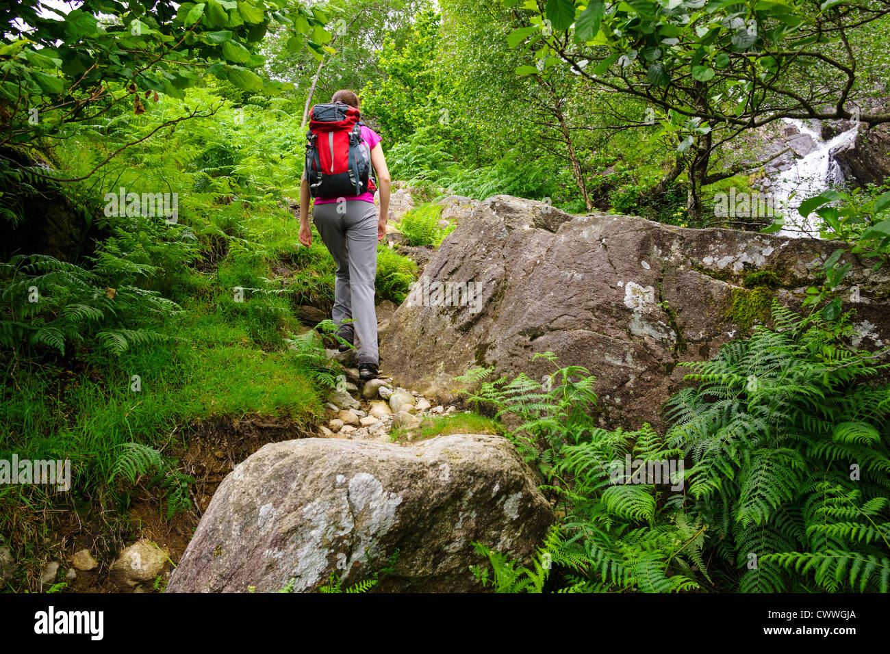 Woman walking up steep hill hi-res stock photography and images - Alamy