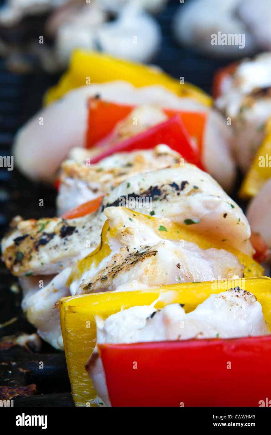 chicken and pepper kebabs slowly cooking on the barbecue Stock Photo
