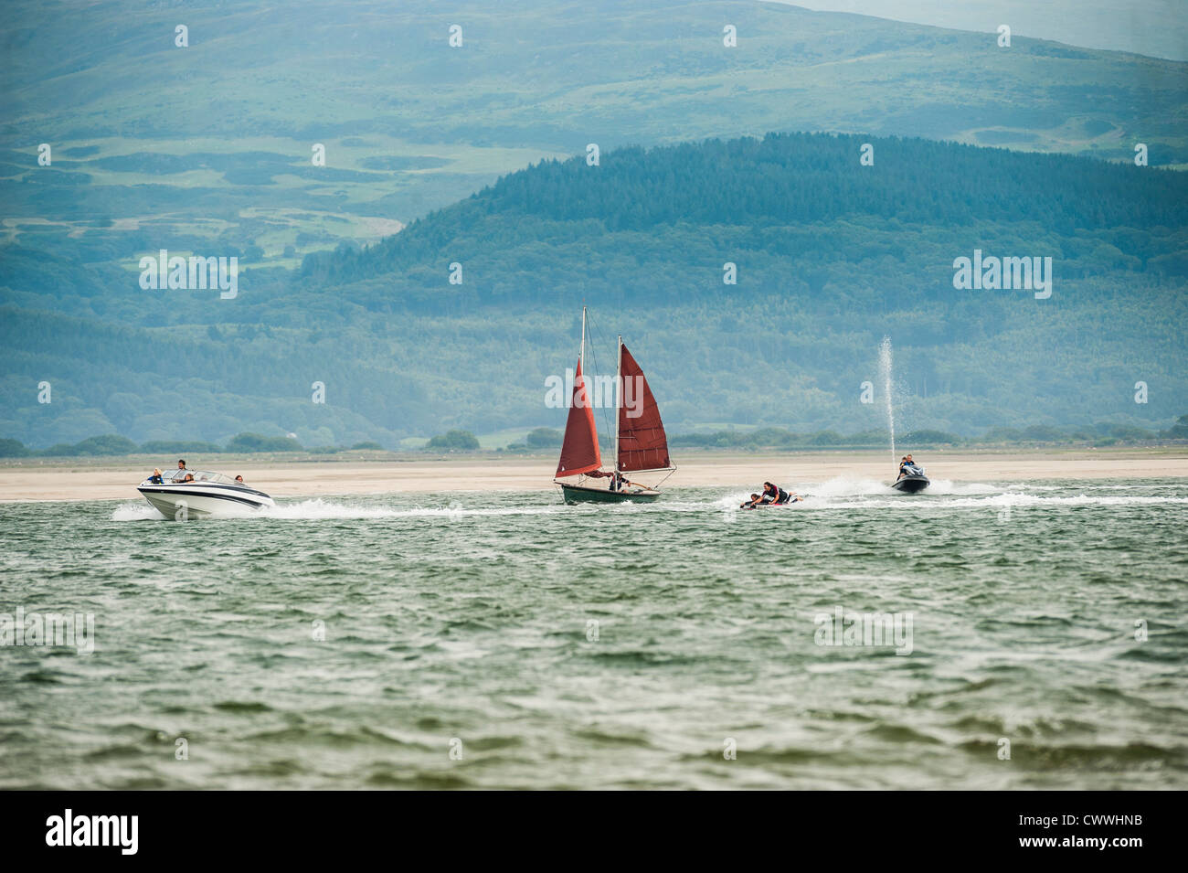A sailboat, jet ski and powerboat on a August afternoon, Ynys las, Dyfi