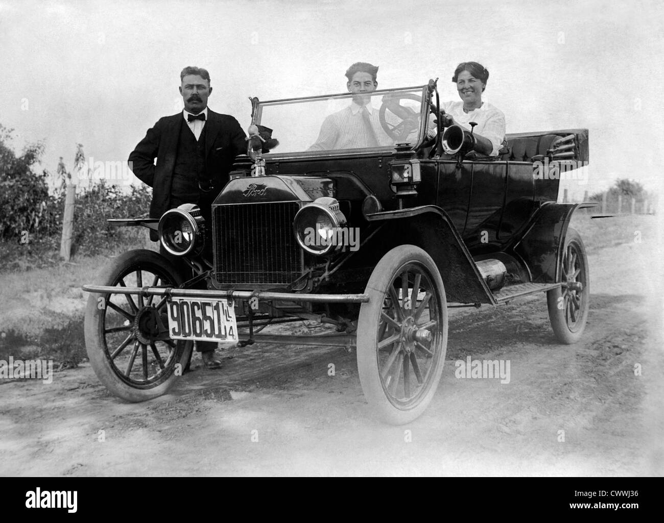 Two Men and a Woman with a Ford Model T Automobile, Circa 1914 Stock Photo