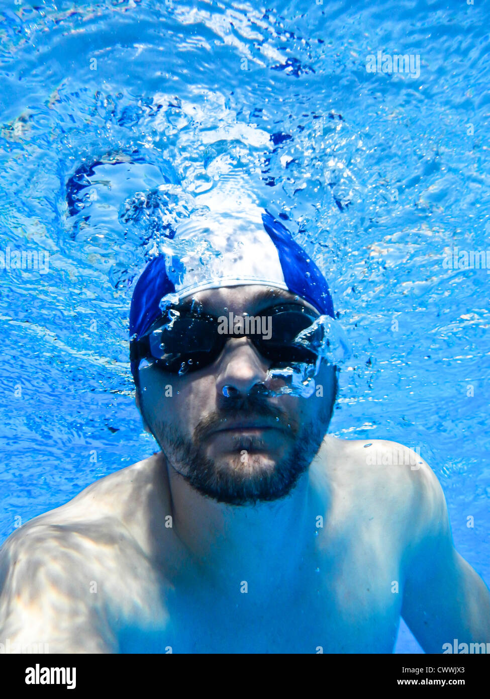 Man swimming with glasses underwater in pool Stock Photo Alamy