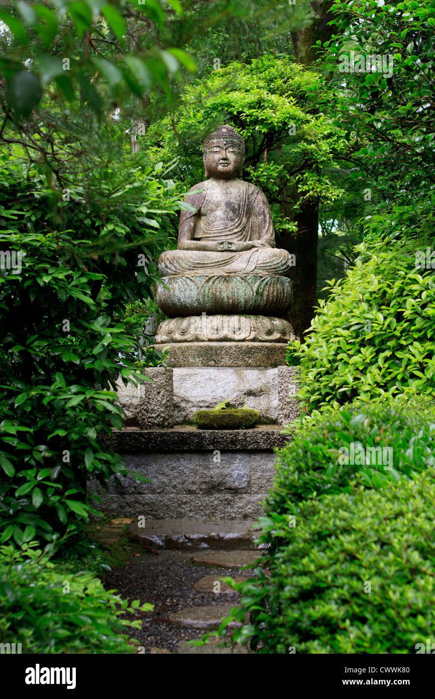 A stone Buddha statue in the grounds of RyoanJi Temple in Kyoto, Japan