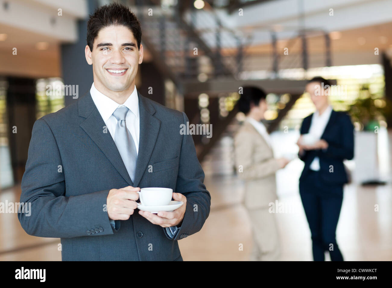 handsome businessman having coffee break in office Stock Photo