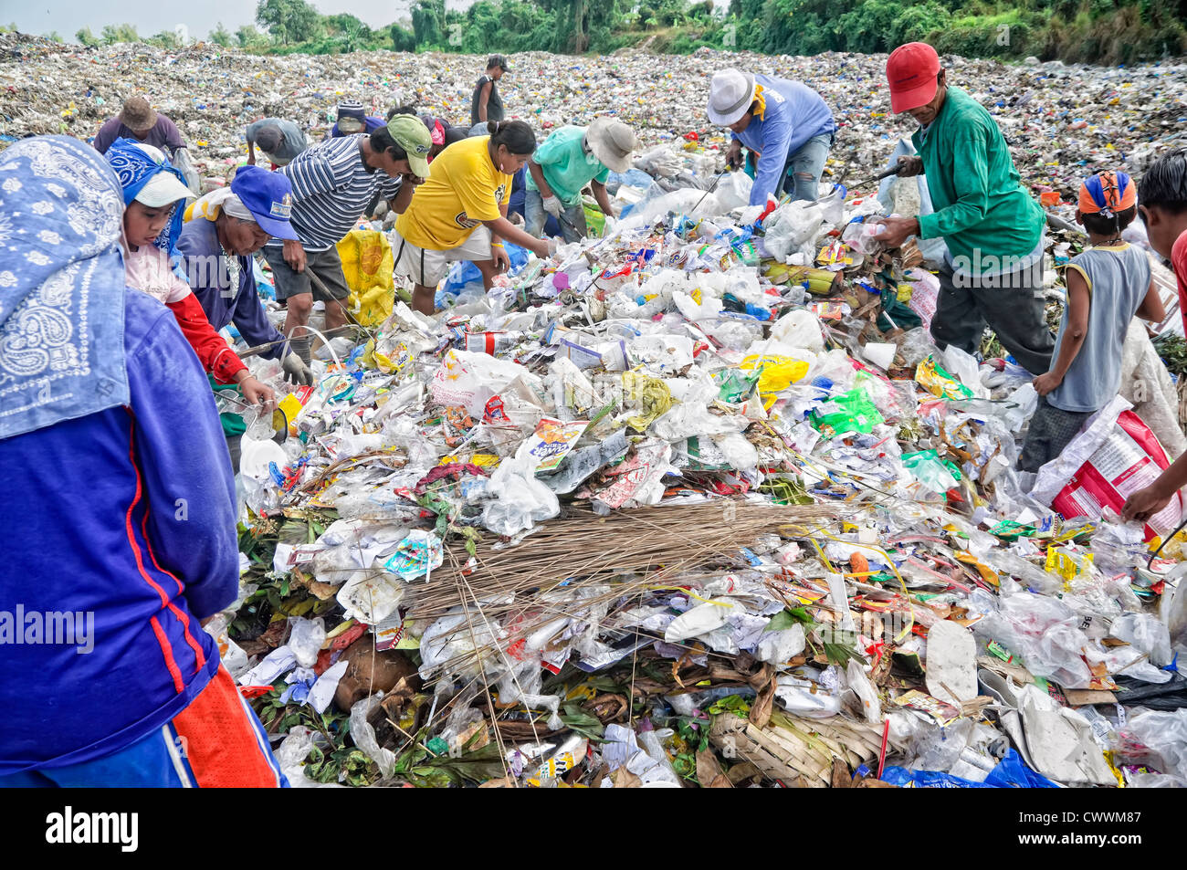 CAVITE, PHILIPPINESS. - FEBRUARY 12: Unidentified scavengers rummage for recyclable items in the Philippines Stock Photo