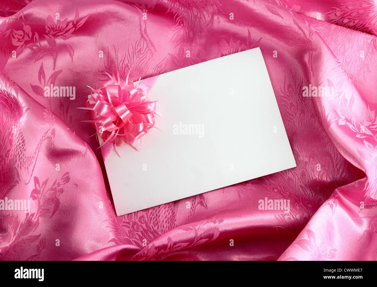 Blank gift card with ribbon on pink satin Stock Photo - Alamy