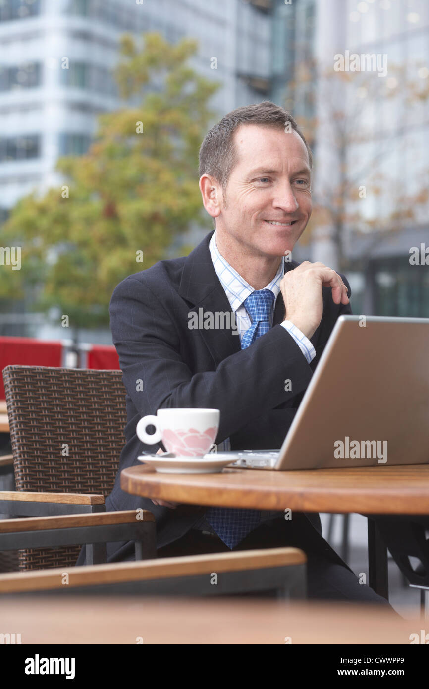 Businessman working on laptop at cafe Stock Photo