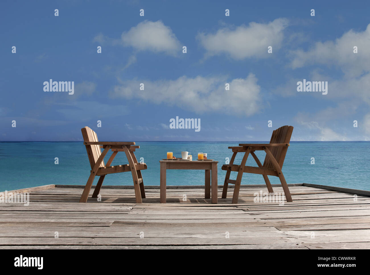 Table and chairs on wooden dock Stock Photo Alamy