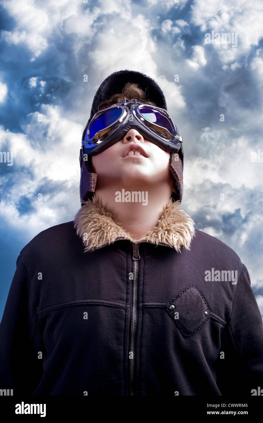 A little boy dreams of becoming a professional pilot. Vintage aviation hat. Stock Photo