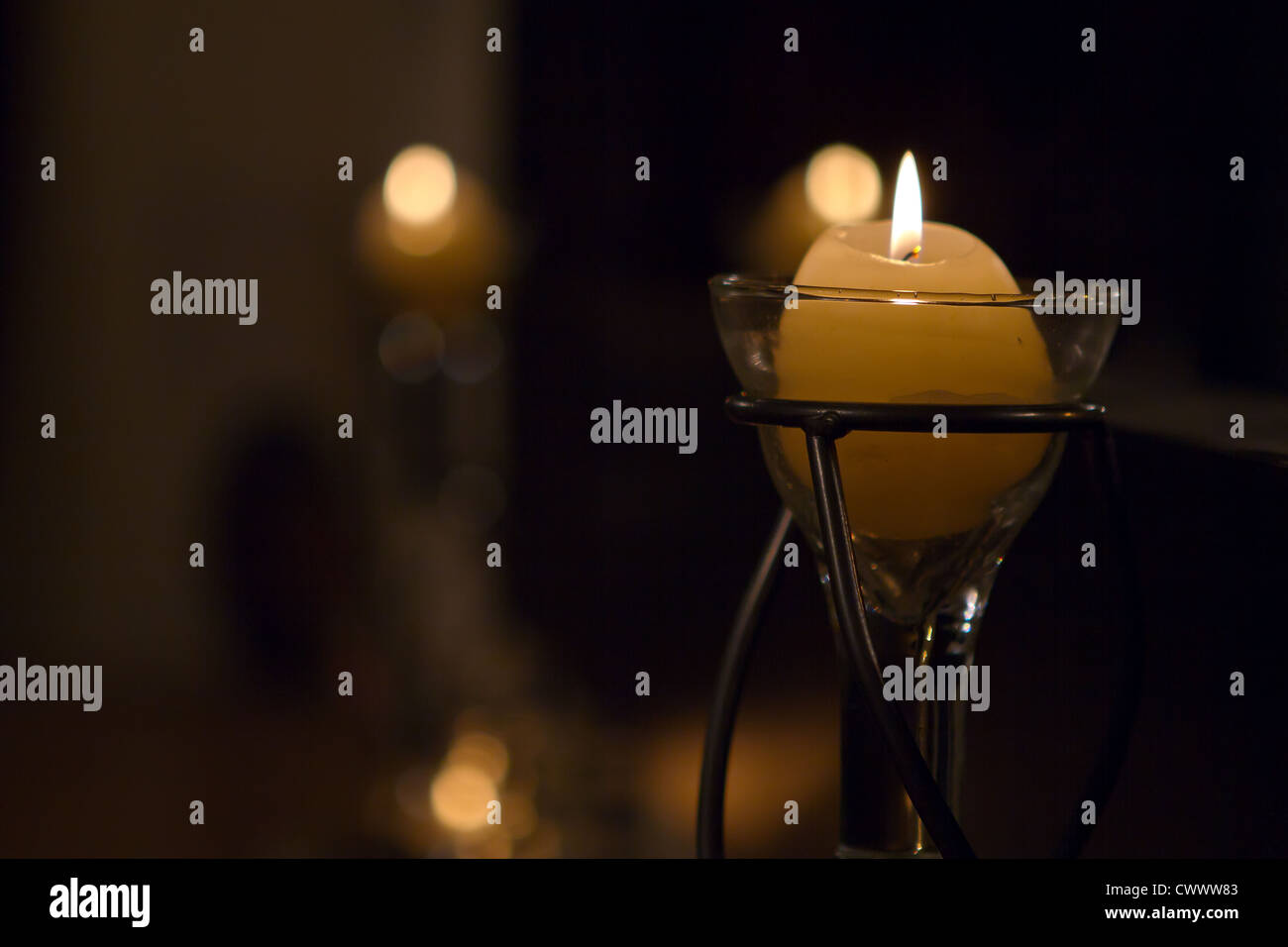 Candles slowly burning in a lounge interior Stock Photo Alamy