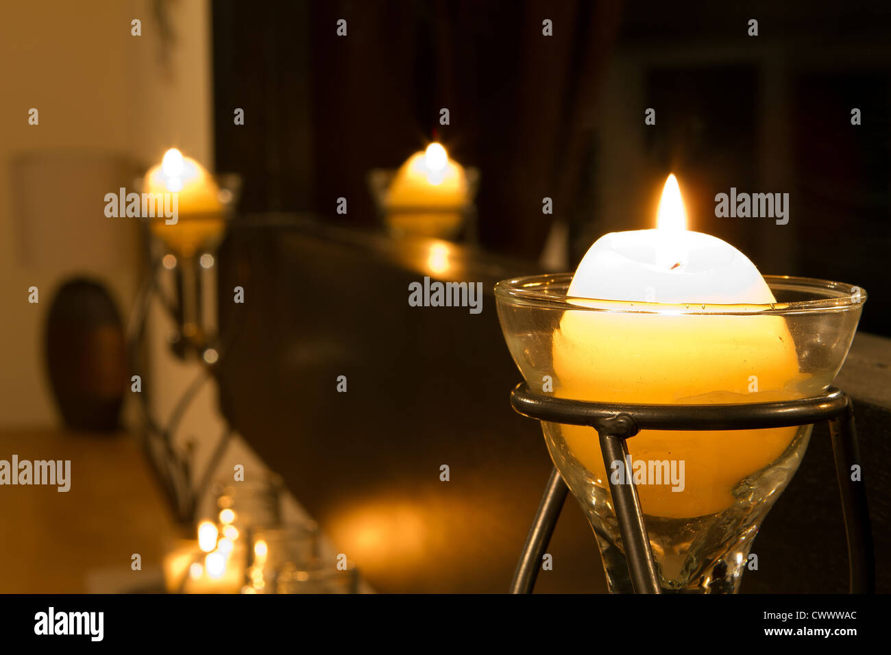 Candles slowly burning in a lounge interior Stock Photo Alamy