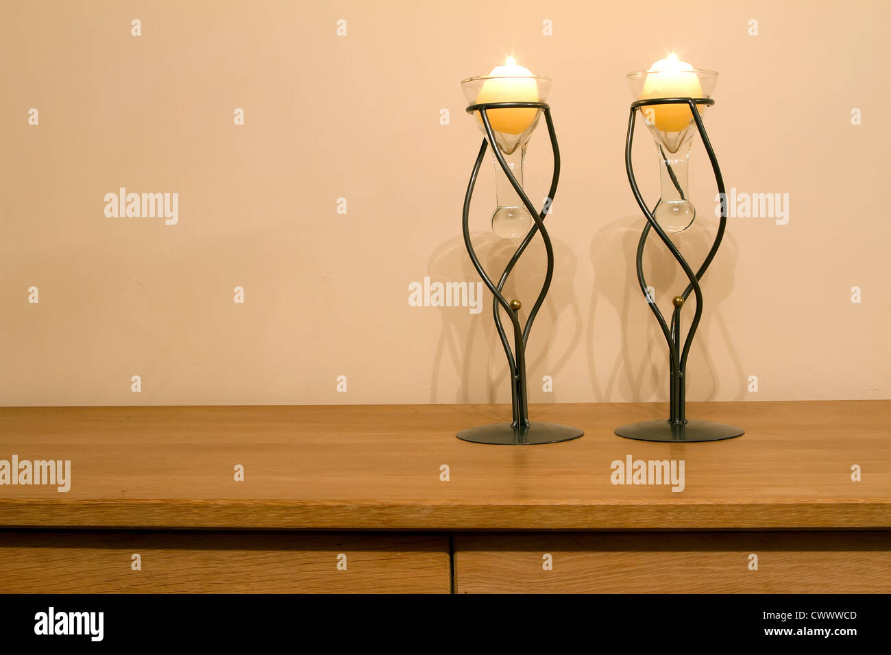 Candles slowly burning in a lounge interior Stock Photo Alamy